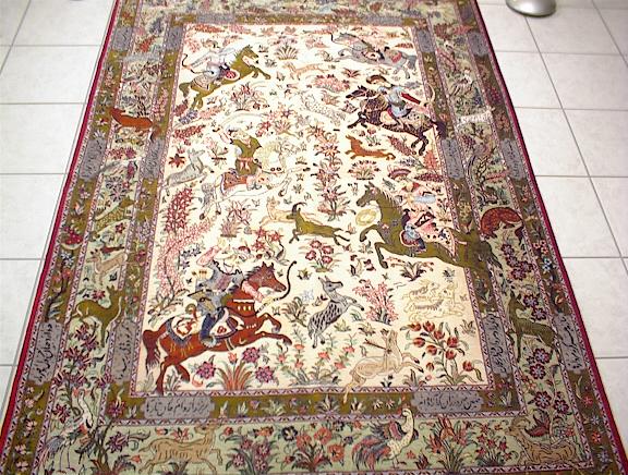 Pure Silk Qom Hunting rug with a poem added to the border. In addtion to the picture carpet design, the weavers will often add a story line in the form of an ancient poem to explain the scene in the Persian Qom rugs.