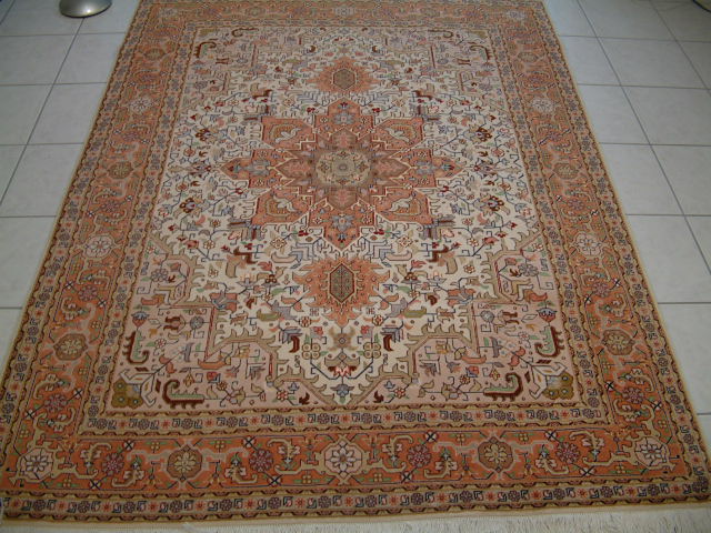 Large Persian Tabriz Heriz rug with the traditional design and color combination. These type of Persian rugs are popular with clients who are looking for a south-western style Persian rug similar to that of Native American rugs.