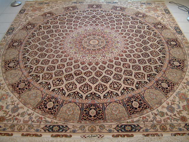 This oriental carpet is a 60 raj square Persian Tabriz rug with a large round design and delicate artwork in each corner. As with all 60 raj Tabriz rugs, this Persian carpet has a silk foundation and features over 400 kpsi, which is exceptional for Persian Tabriz rugs.