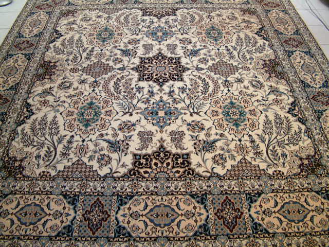 A square Persian Nain carpet with a very unique design and shape. Square oriental rugs are a bit of a challenge to find and large square rugs like this Nain carpet are even more rare. Although most Nain carpets tend to have very traditional designs, I tend to feature Persian Nain carpets that are unique and different from most others. The quality of this and all of my Nain carpets are extremely high and tend to have around 600 kpsi.