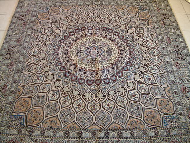 Large room sized Nain Persian rug with a very unique design and very traditional Nain carpet colors. Nain rugs are made near and in the city of Isfahan and they come in various types of quality like most other Persian carpets. The Nain rugs that I feature are made of a very high quality and to have over 600 kpsi is not unusual. To begin with, all of my Nain oriental carpets are 6-lah quality and I always look for unique designs like this one.