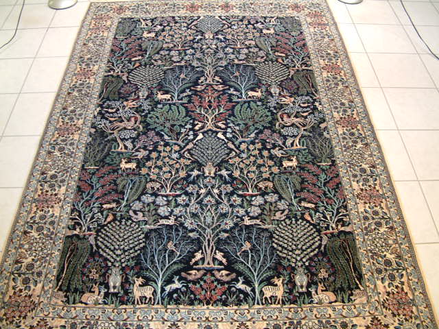 Nain Persian rug with a design called a tree-of-life, which is very rare in high end 6-lah Naiin oriental carpets. As with all of my Nain rugs, this carpet has over 600 kpsi and is an extremely fine example of a true showpiece rug. The design is such that it is ideal for a formal area and some of my clients like to hang these picture carpets oon walls. Nain rugs tend to be very traditional in colors and design, so a Naiin carpet like this one is very different from the others.