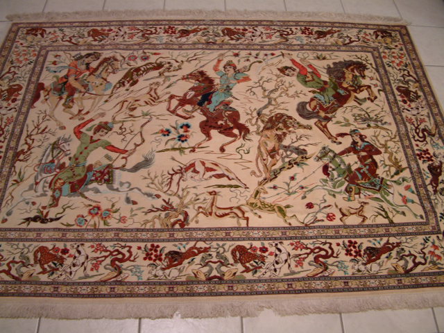 This pure silk Persian carpet comes from the city of Qom and it features a horizontal hunting scene, which is very rare in oriental rugs. Qom rugs are best known for their pure silk carpets and are among the finest handmade Persian rugs. All of the ones that I offer have over 700 kpsi and are designed to be showpieces to be displayed in formal areas. Some of my clients also like to hang these silk carpets and a few of the Qom rugs have also been framed.