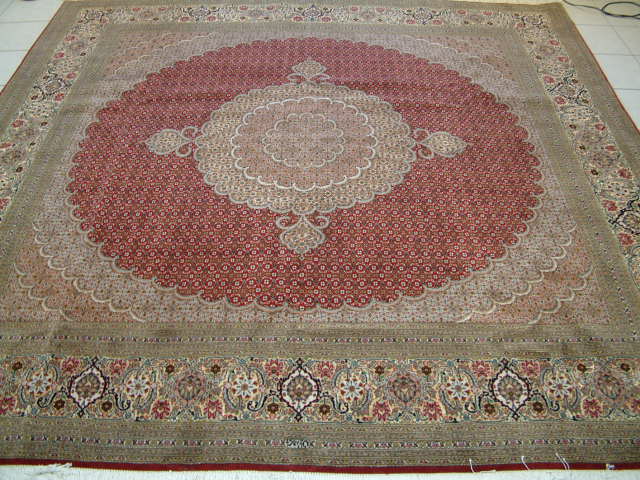 Square Tabriz Mahi Persian carpet made by the Pirouzian family, who make some of the most unusual and finest Tabriz Mahi Oriental rugs. Unlike the standard Tabriz Mahi rugs, these Persian carpets are extremely fine and often feature much more added silk highlights. Mahi Tabriz carpets are often used in high traffic areas, but the high quality rugs like this square Persian rug are also perfect as a showpiece. As with all Pirouzian rugs, this piece has a signature and it is a great example of a high end Oriental carpet.