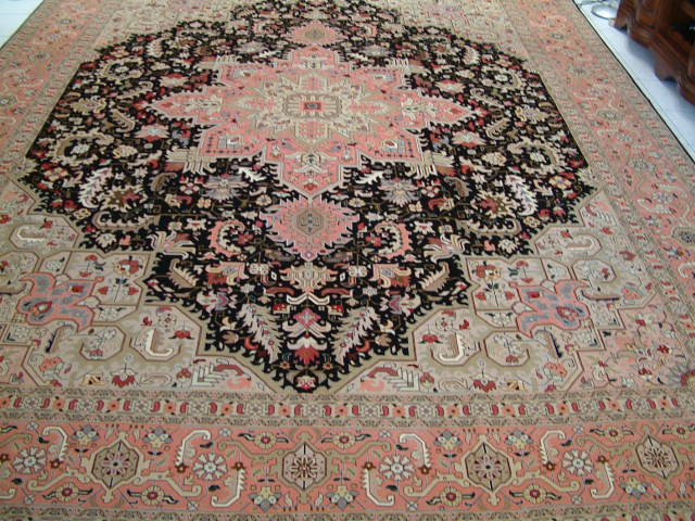 Another popular design in my Persian rug is the Tabriz Heriz oriental rugs, which feature a very geometric pattern very different from most other Persian carpets. The Heriz design comes from the region that is slightly to the northeast of Tabriz and gets it's influence from the Russian Kasak rugs. As you can see, there are no round edges in these Persian carpets to and especially the high end Tabriz oriental rugs with this design feature lots of silk highlights. The colors in this Persian rug design can vary and what you see here is a typical Heriz Tabriz Oriental carpet with the very dark main color and lots of bright silk highlights.