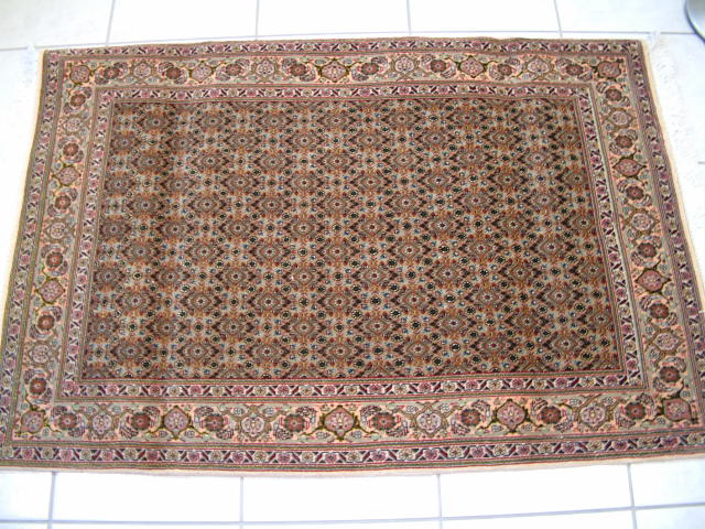 Light colored Tabriz Mahi Persian rug.